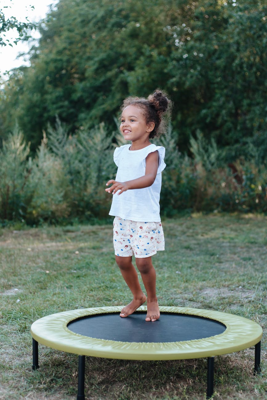 a young girl playing trampoline