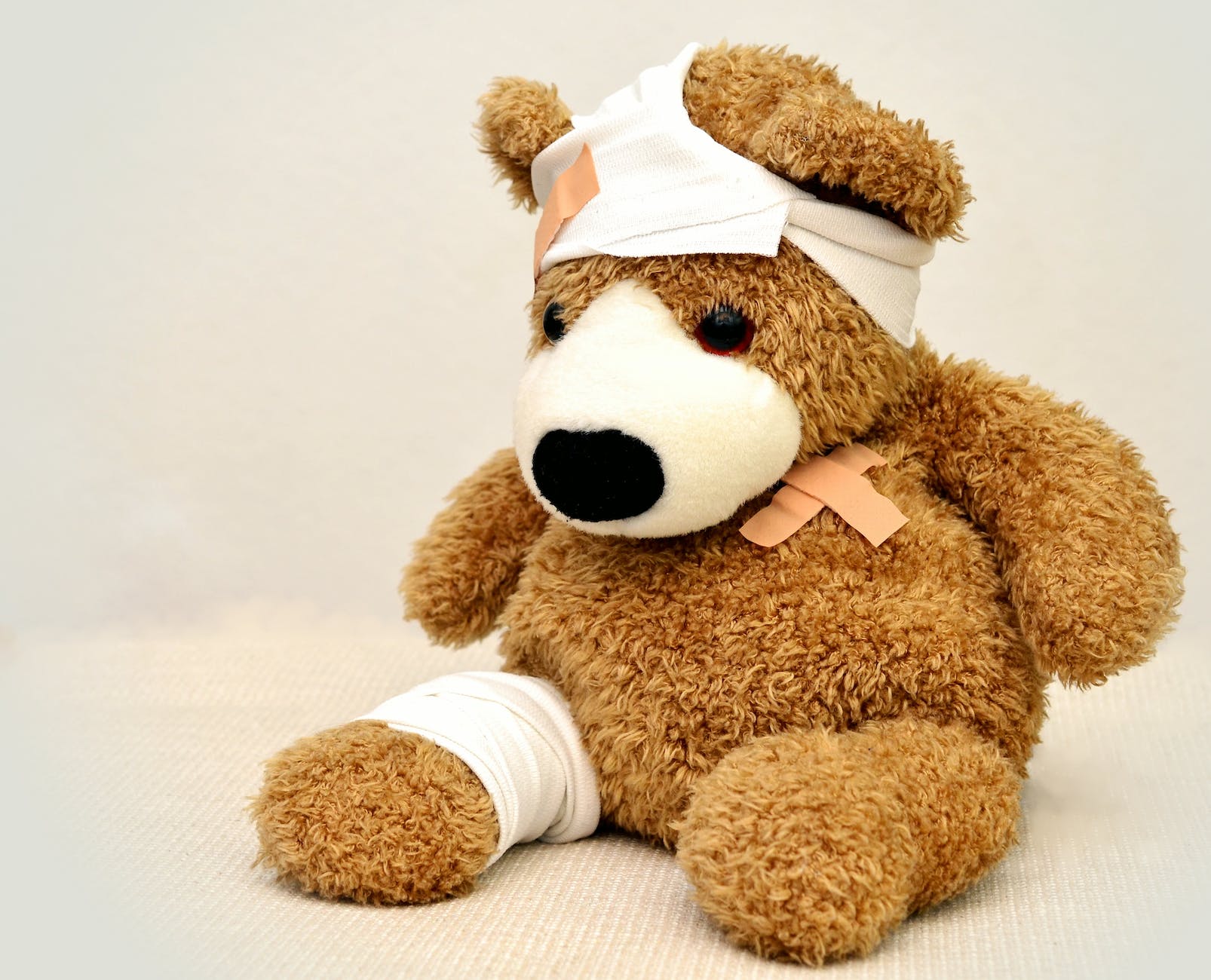 brown and white bear plush toy depicting common trampoline injuries